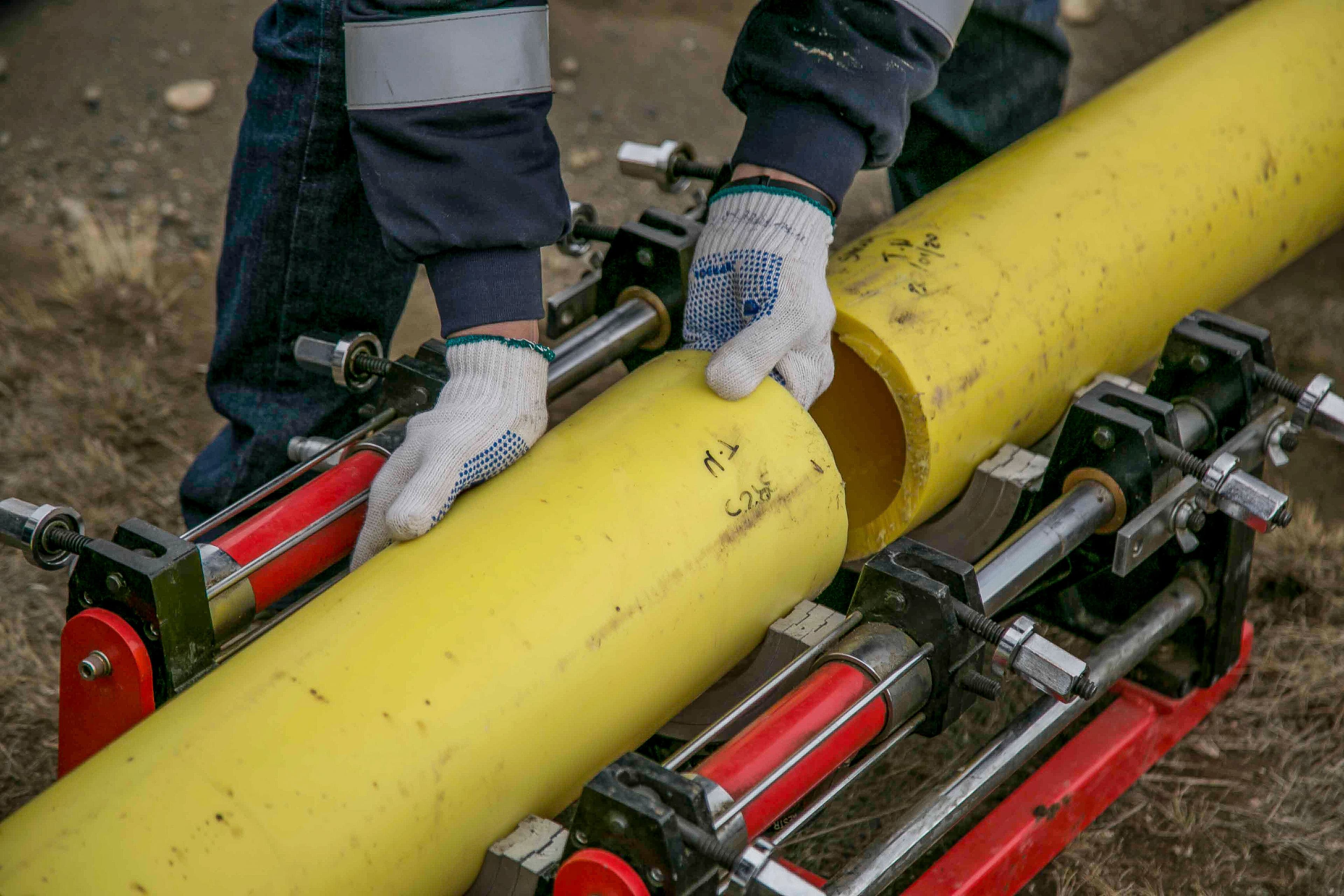Placeholder - worker inspecting a pipe for quality control